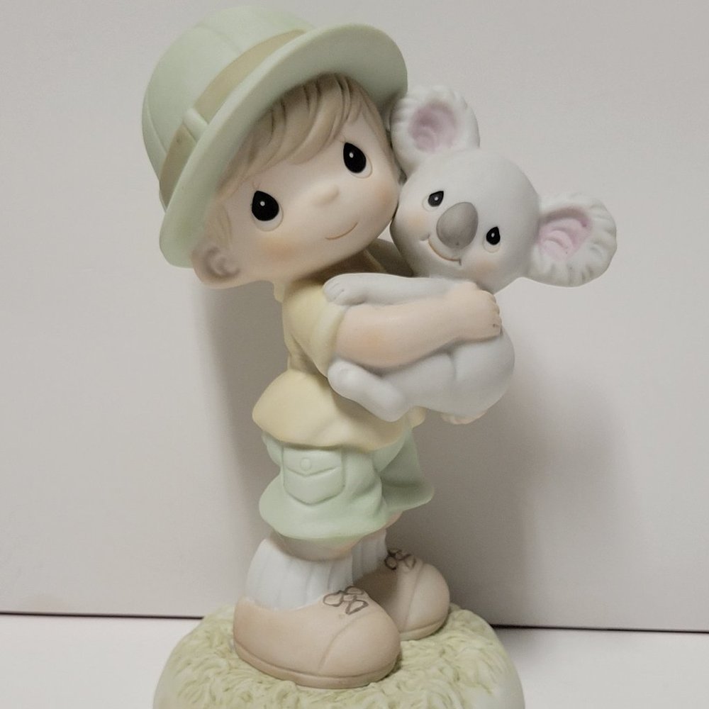 Precious Moments Figurine "Hugs Can Tame the Wildest Heart".